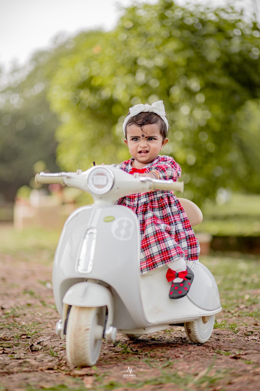 Child on a toy scooter, outdoor photoshoot